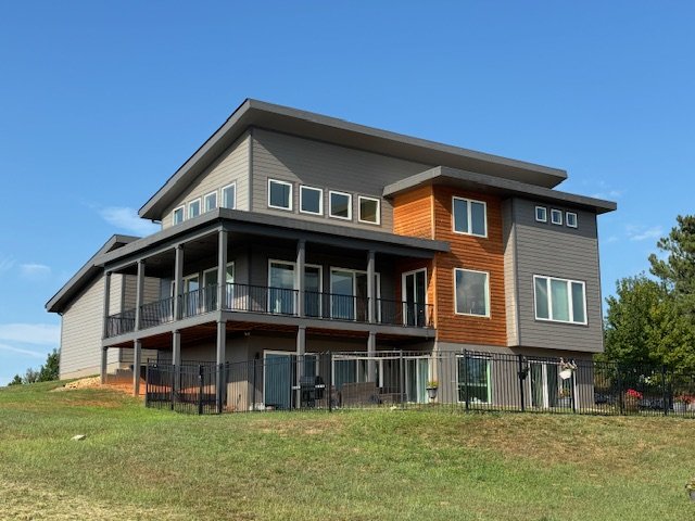 Gray contemporary house with cedar accent and stacked decks