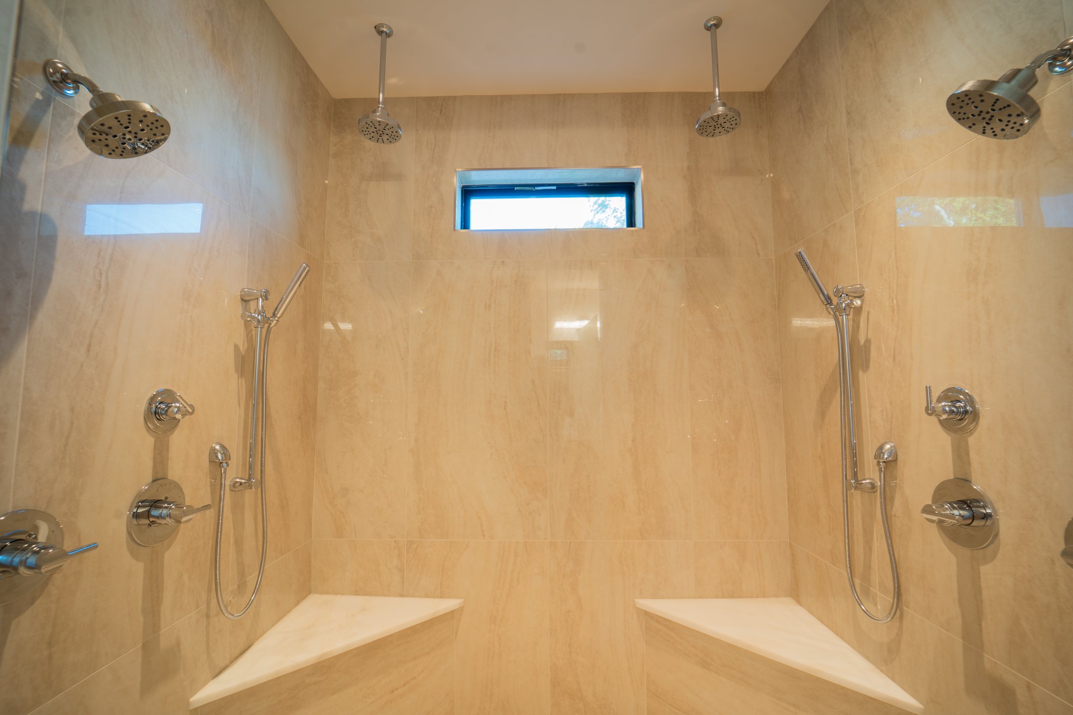 House on the lake dual shower with stone tile and two rain heads
