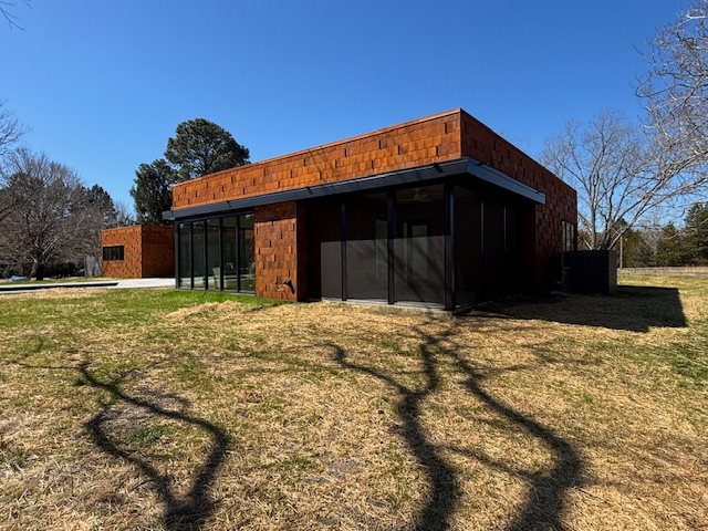 Contemporary metal house with deep eaves and glass